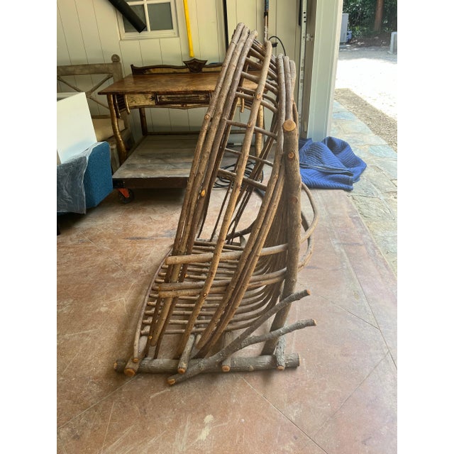 Custom made this is a very unique hanging adirondack twig lounge chair. Can be hung with rope and hooks. We have one hook...
