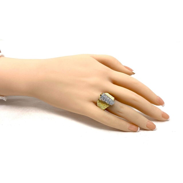 This is an authentic wide band ring from Henry Dunay, it is crafted from 18k yellow gold with white gold accent featuring...