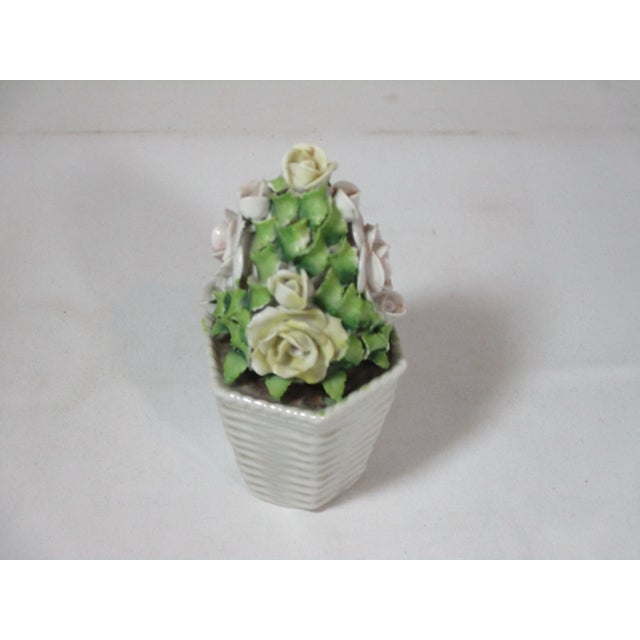 Lovey petite hand painted porcelain rose topiary, made in Germany. The topiary is decorated with yellow and rose-colored...