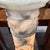 Antique Liberty-era alabaster column from the 1920s electrified with a lamp. Relief work with leaves and grapes....