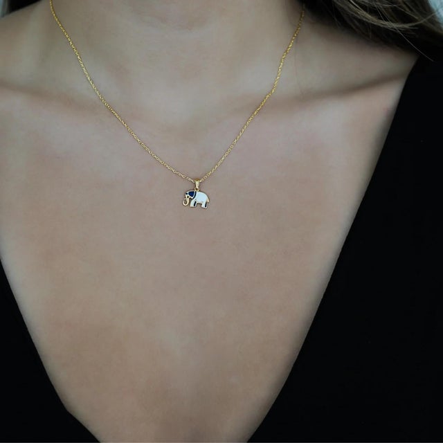 The Gold Blue And White Elephant Necklace is a stunning piece of jewelry for those who value unique and meaningful...