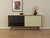 A classic sideboard by Lothar Wegner from the 1960s. High-quality walnut veneer body with two glass sliding doors in black...