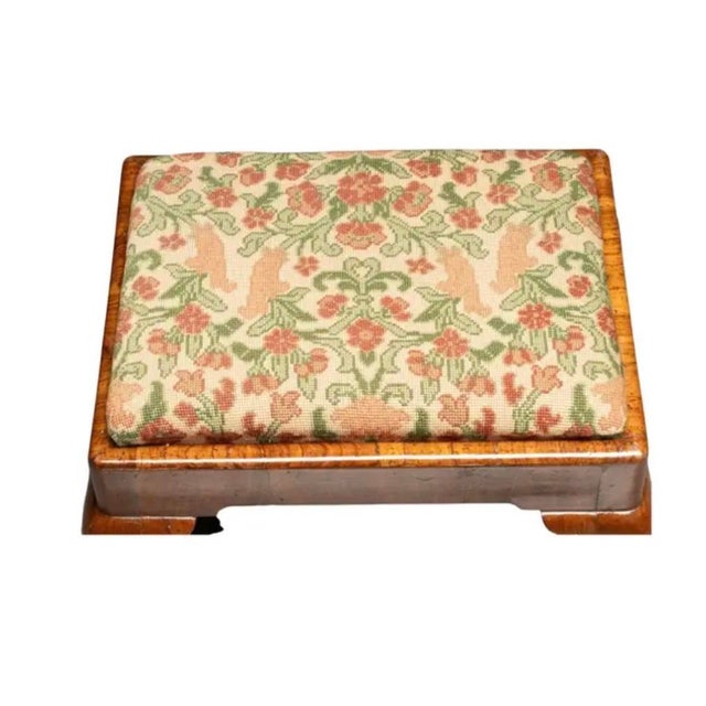 Queen Anne Mahogany Footstool with Needlepoint Upholstered Seat. The needlepoint tapestry features a soft palette in...