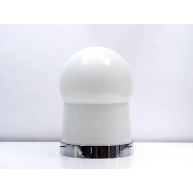 The rare ‘Paracarro’ lamp designed by Sergio Asti for Bilumen in 1972 features a large milk glass shade that sits in a...