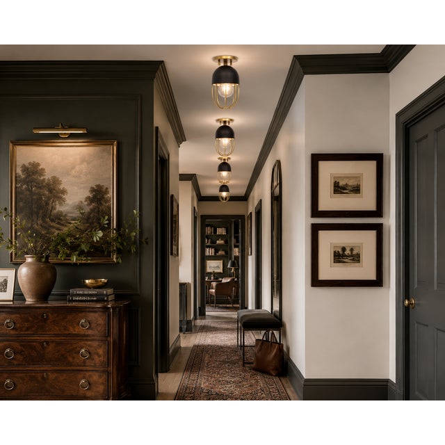 A striking set of nine Mitzi Haley semi-flush mount ceiling fixtures, combining matte black metal with warm aged-brass...