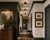 A striking set of nine Mitzi Haley semi-flush mount ceiling fixtures, combining matte black metal with warm aged-brass...