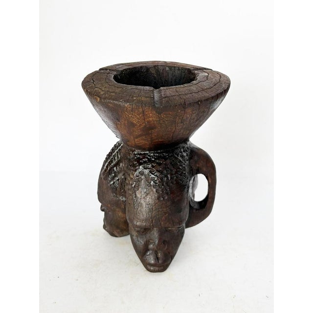 A three-sided carved wooden ashtray, a French handcrafted piece from the 1960s with a raw and expressive character. This...