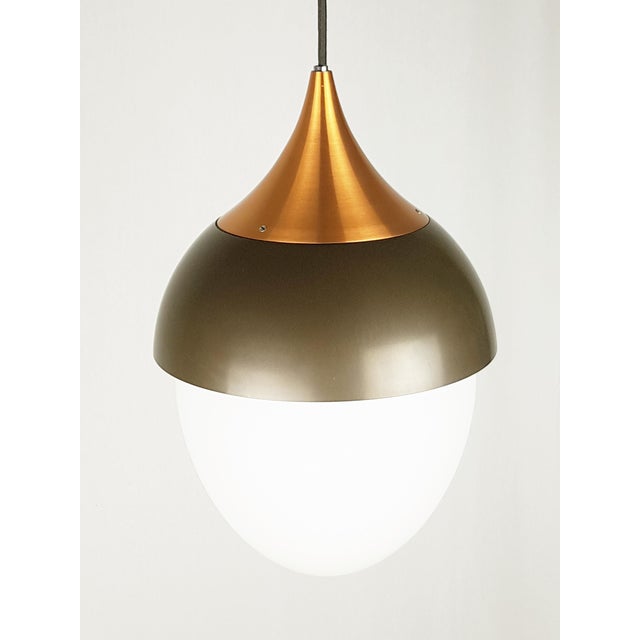 A rare and elegant pendant lamp produced by Stilnovo in the 1960s.The main body of the lamp consists of 3 elements: 2 in...
