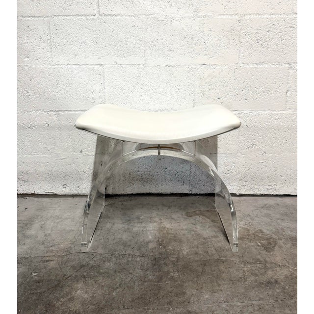 Contemporary Marlowe stool featuring a contoured white leather seat supported by sweeping arches of clear Lucite. The...
