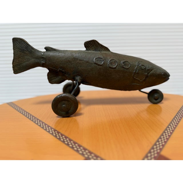 Design Plus Gallery presents "Taxi Trout" by Stephen Maxon. A sculpture of brass with a sense of humor much like the...