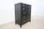 This French Louis XVI style highboy by Drexel features a striking black lacquered finish complemented by refined brass...