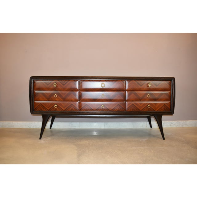 A vintage Italian nine-drawer commode attributed to Vittorio Dassi, dating to the 1950s. The long, low cabinet is...