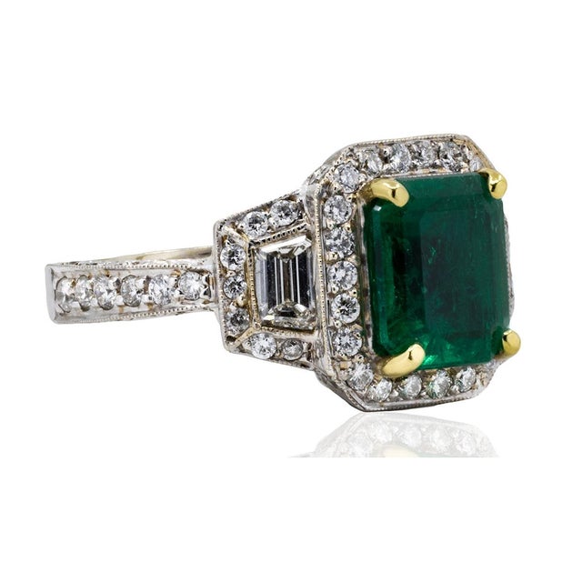 18k White gold ring with one 2.84 carat Colombian emerald and 1.63 carats of round and trapazoid diamonds 10.57 grams