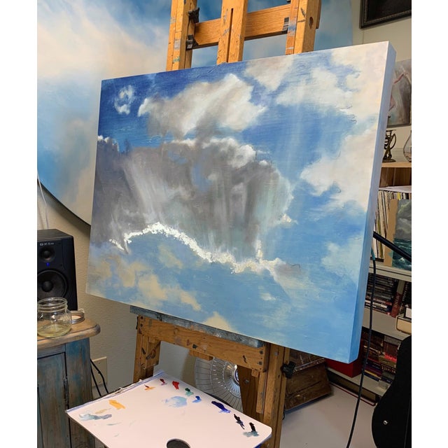 This painting features a dynamic sky, where swirling clouds interact with vibrant blue hues, creating a sense of movement...