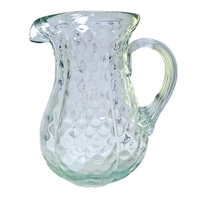 This is a beautiful green glass pitcher is textured very much like a gourd or pumpkin. Measurements : 9.5" x 9" x 6.5"L...