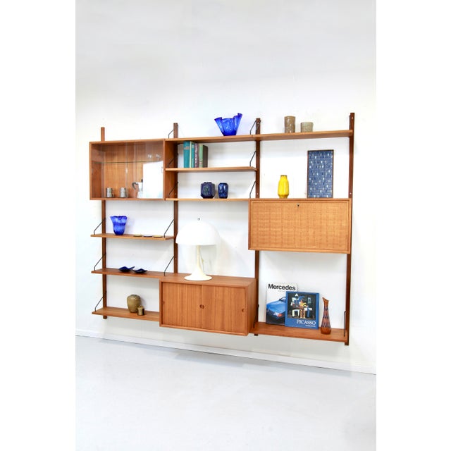 Three-strip teak "Royal System" by Poul Cadovius for sale! Beautiful, timeless, modular wall shelf in pristine condition....