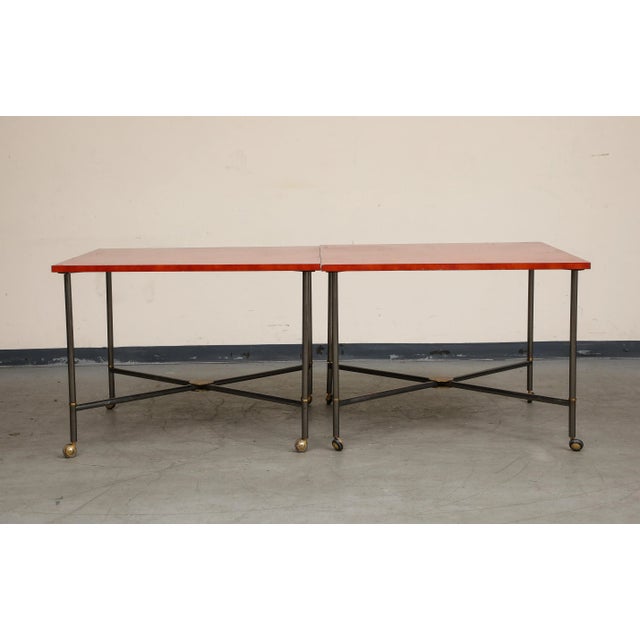 Midcentury bronze two-piece dining table on casters with red lacquer top and brass accents. Two squares join to form a...