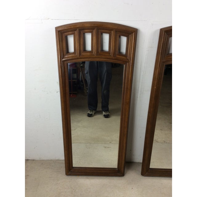 This pair of mid century modern mirrors features hardwood frame, original walnut finish, unique arched top with cutaway...