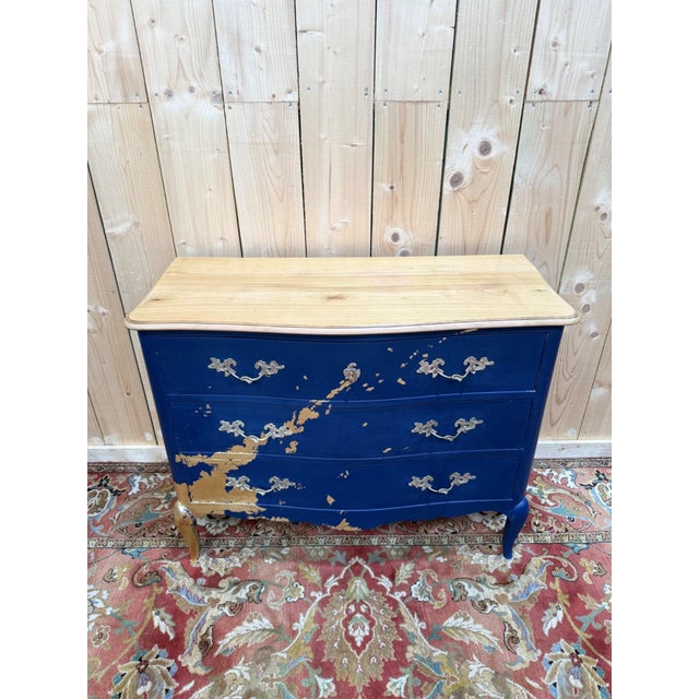 A louis xv style three-drawer commode, hand-painted in the workshop in royal blue with applied gold leaf in a diagonal...