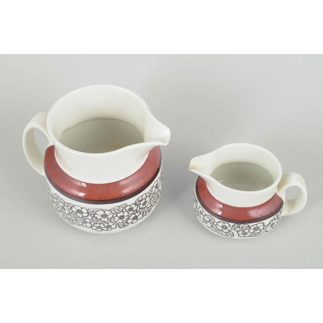 Gefle Stoneware “Agneta” 2 Pitchers, 1970s. Set of two stoneware pitchers in different sizes, decorated with the...