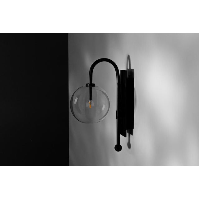 A bubble of mouth-blown glass hangs inverted on an arched stem: a nocturnal flower from the landscape of Naples bay....