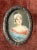 This antique 19th century miniature painting depicts an Austrian woman, showcasing the intricate details and craftsmanship...