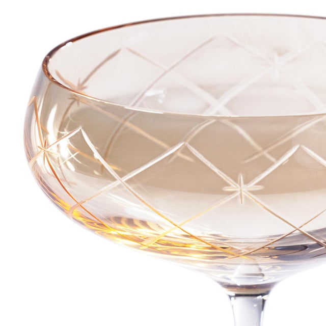 A stunning addition to any bar collection, this set of four coupe glasses features lustrous, hand-painted color cups with...
