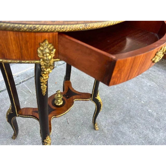 French 19th Century Louis XV Style Kingwood and Marquetry Inlaid Ormolu Mounted Side Table. Oval shaped top with elaborate...