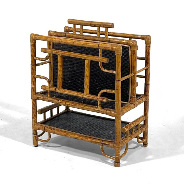 This handsome magazine rack with a frame of rattan supporting pannels of ebonized cane has two vertical compartments on...