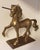 A striking vintage brass unicorn sculpture by Enesco, dated 1982, presented in a beautifully sculptural prancing pose atop...