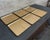 Set of six square embossed aluminum gold tone trays with coaster divot manufactured by Kaymet, UK. The model number is...