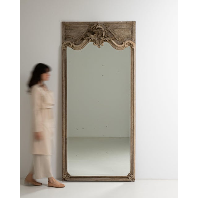 This early 19th century Louis XV mirror from France is finished in gold, worked in oak. Its design carries the Louis XV...