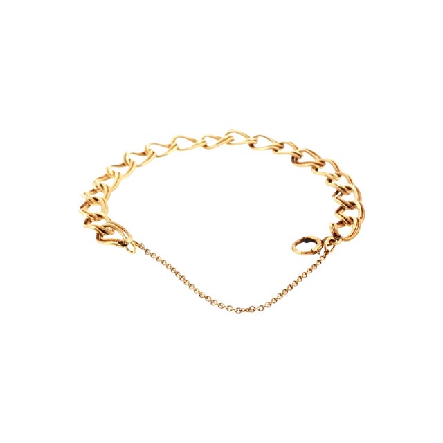 A Mid-century 14k gold chain bracelet. The links are oval-shaped, and 1/2 have a textured finish. The bracelet is sizable....