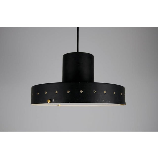 Italian mid-century pendant lamp attributed to stilnovo from the 1960s, featuring a striking combination of black...