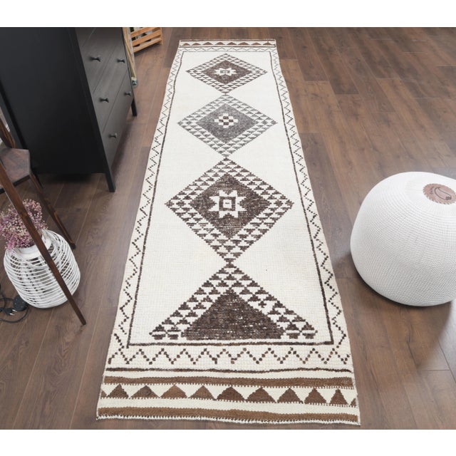 Vintage Turkish Hand-Knotted vintage rug is a semi-Vintage runner rug.'70s Eastern region of Turkey's unique rug is...