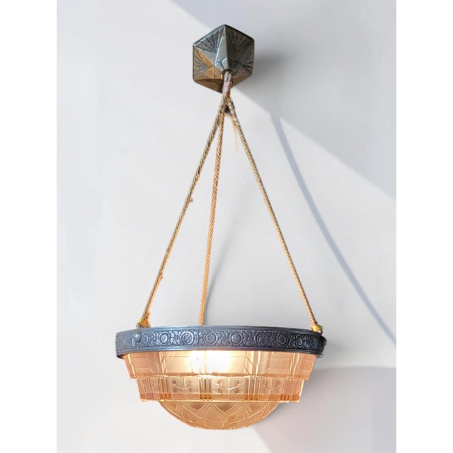 Important Art Deco pendant light, circa 1920-30, in molded pink glass. Geometric design and interesting shape. Note the...