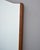 An elegant Italian wall mirror featuring a tall, vertical form with a distinctive serpentine-cut top edge — a graceful...