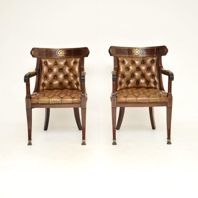An exceptional pair of antique Regency period brass inlaid leather armchairs. They were made in England, they date from...