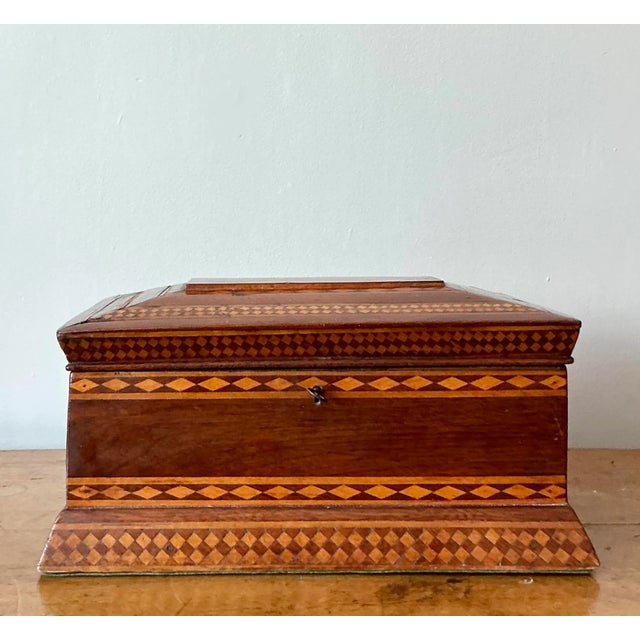 Embrace the distinguished charm of the 19th century with this exquisite antique marquetry box. A stunning example of...