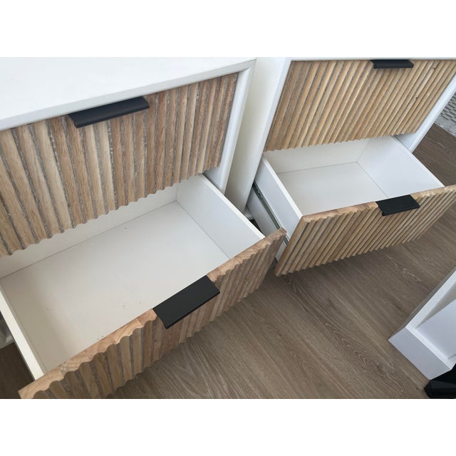 A set of West Elm Quinn nightstands bought two years ago new. They have sustained some wear, mainly inside the drawers...