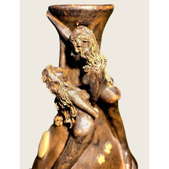 8” high 5.5” wide, a very unusual thick walled terra cotta vase with two highly raised mermaids each having thin strands...