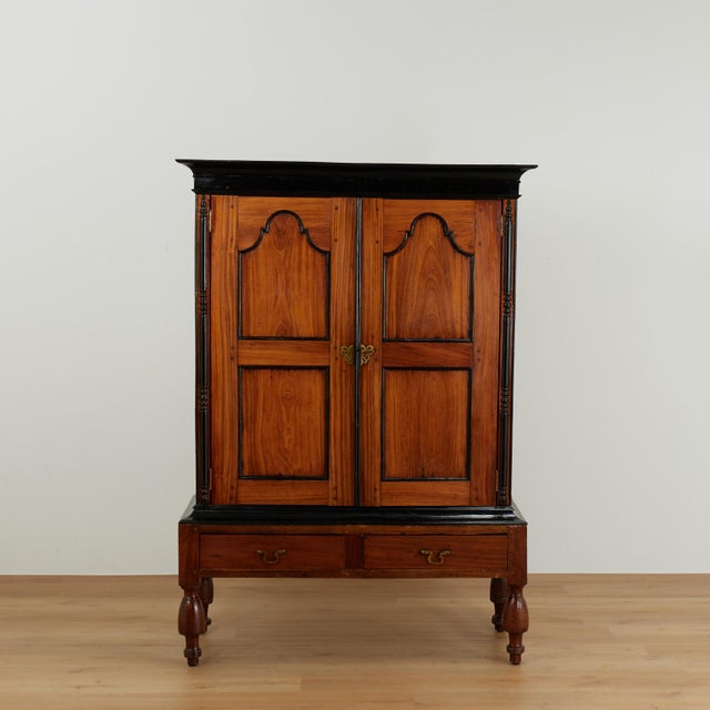 19th century Ceylonese colonial cupboard constructed of richly figured teak with contrasting ebonized moldings and turned...