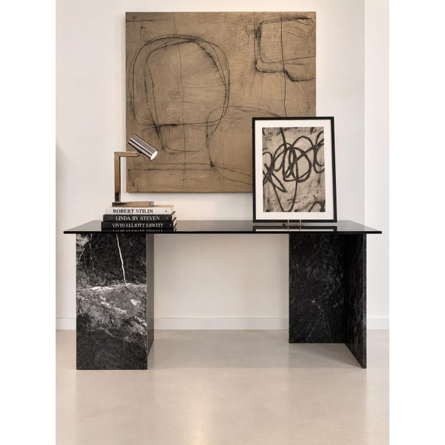 A sophisticated one-of-a-kind desk combining a vintage marble base with a custom smoke-grey glass top. Created by our...