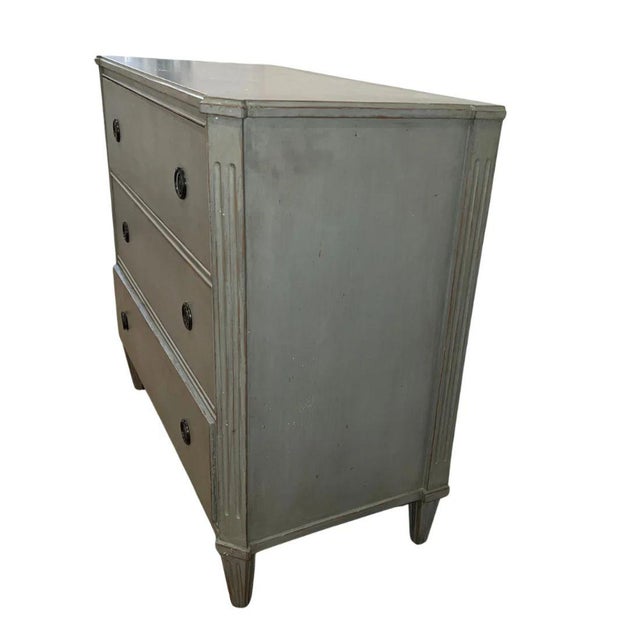 A Swedish Gustavian style three drawer chest hand painted celadon green with fluted edges to each side and tapered and...