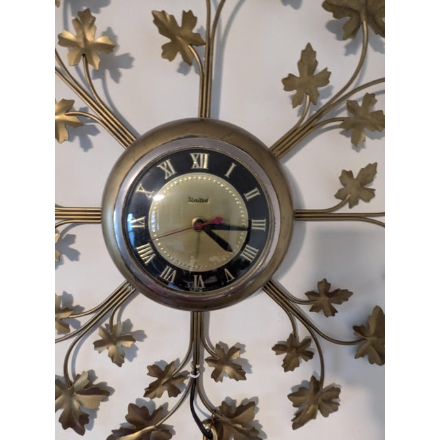 This vintage large 1960s United Leaf Electric Wall Clock in Goldtone is a stylish and functional addition to any living...