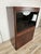 An elegant 1970s Italian display cabinet made of rosewood veneer, featuring a rigorous, geometric design typical of...