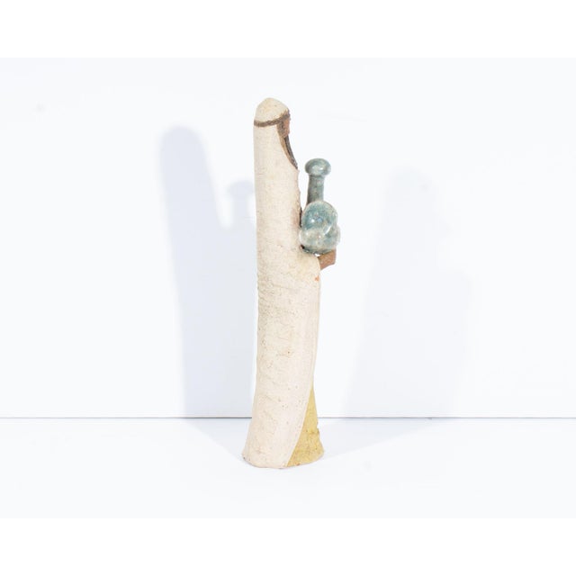 A studio pottery sculpture by the Israeli artist David Kalderon. This sculpture depicts a woman wearing a long tunic and...