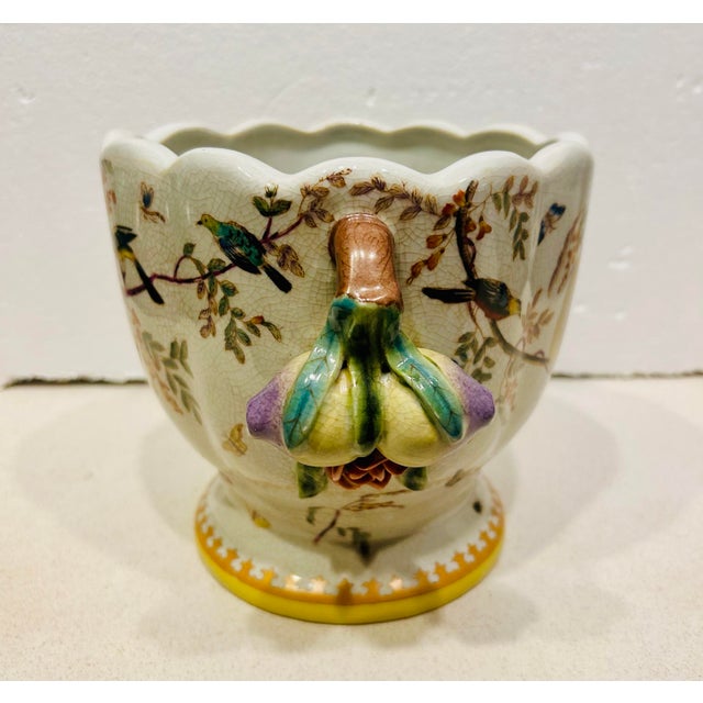 This lovely porcelain cachepot features a bird and floral patter. Scalloped edge on top gives it a unique look. This piece...
