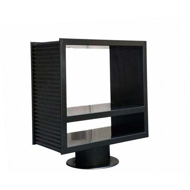 Modernly designed swivel cabinet, often used as a contemporary designed center console table or a TV stand, featuring a...
