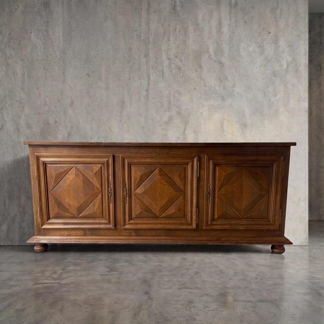 Masterful geometric relief carving transforms substantial oak into a dynamic architectural statement. Four striking...